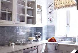 Here, the white and grey subway tiles generate textural appeal. 10 Gray Living Rooms That Aren T A Total Snooze Fest Grey Blue Kitchen Grey Kitchen Cabinets Chic Kitchen