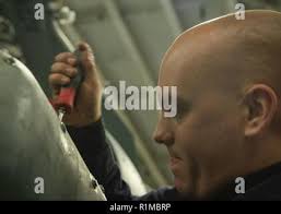 ATLANTIC, OCEAN (Oct. 23, 2018) Aviation Electronics Technician 3rd Class Vanessa  Cabrales, from Peoria, Arizona, assigned to Helicopter Sea Combat Squadron  (HSC) 22, sands the extended weapon system panel of an MH-60S