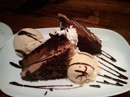 A dark cocoa cake covered with two kinds of chocolate. The Chocolate Stampede From Longhorn Steakhouse Your Taste Buds And Your Pancreas Will Explode Food Longhorn Steakhouse Sweets