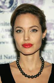 Angelina Jolie S Ever Changing Beauty Looks Angelina Jolie Beauty How To Style Pearls