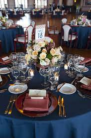 Love The Color Tablecloths With The Accent Napkins And Chairs Gold And Burgundy Wedding Navy Wedding Decorations Navy Wedding Centerpieces