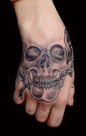 45 A Simple Skull Tattoo Design On Hand Hand Tattoos For Guys Skull Hand Tattoo Simple Hand Tattoos