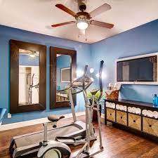 The gym is made interesting by the neutral colors on the walls and ceiling. 70 Home Gym Ideas And Gym Rooms To Empower Your Workouts Gym Room At Home Workout Room Home Home Gym Decor