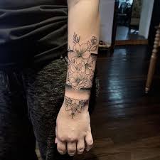 The wrist has always been an appealing tattoo location. Fineline Floral Tattoo Wrapping Around Wrist Designed And Tattooed By Jax Artist Silveran Wrap Around Tattoo Flower Wrist Tattoos Wrap Around Wrist Tattoos