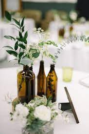 Industrial Modern Wedding With A Greenery Wall Ruffled Industrial Wedding Centerpieces Affordable Wedding Centerpieces Wedding Bottles