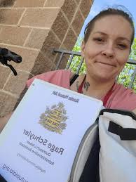 Man holding sign for Plan B money near Tanger Outlets in Pooler