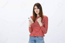 Boyfriend Posted Photo With Ex Girlfriend, Revenge Is Near. Portrait Of  Displeased Angry Pretty Brunette, Raising Clenched Fist And Holding  Smartphone, Finding Out Disappointing News Over Gray Wall Stock Photo,  Picture and