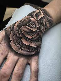 The deep red of the rose is very compelling and matches the tattoos going up the arm well. Money Rose Tattoos For The Love Of Money