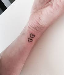 I choose to believe this woman's tattoo is a warning to others that she will vanquish her enemies in the most gruesome manner imaginable, but that's just my interpretation. Identical Love Hearts Tattoo After Searching For Simple Hearts Without Any Luck These Were Found And Placed So Cutely Love Heart Tattoo Tattoos Heart Tattoo