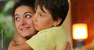 Child hugging young 30 year old woman. Young boy hugs older sister in 4K
