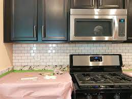 Check out our guide to learn more about installing tile backsplash: How To Install A Subway Tile Kitchen Backsplash Young House Love