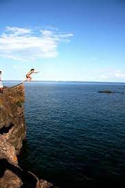 Here, you'll find beautiful beaches, trees, and lengthy hiking trails surrounding this stunning rock formation. 7 Tips To Explore And Cliff Jump Black Rocks Marquette
