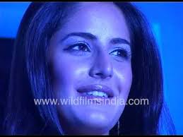 Katrina Kaif walks onto stage in deep blue dress, with Bobby Deol who has  his arm around her waist