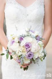Muted purple and yellow roses and dahlias, accented with astilbes, rice flowers, maple leaves, baby artichokes this bridal bouquet is made up of ivory garden roses and astrantia, plus local greenery from thailand, where the wedding took place. Soft And Romantic Lavender Gray And Ivory Bridal Bouquet With Large Peonies Ivory Bridal Bouquet Lavender Wedding Lavender Wedding Bouquet