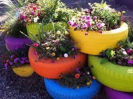 Painted Car Tires Wow What A Great Way To Reuse Non Biodegradable Waste By Incorporating It Into Your Garden As Old Tire Planters Tire Garden Sensory Garden