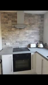 The design of these tiles resemble curved hexagon kitchen wall tiles and has a sophisticated charm that matches the wooden countertops and white cabinetry. Grey Kitchen Wall Tiles Kitchen Backsplash