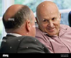 Board member John Tyson, right, speaks with board member Mark Waldrip  during a meeting of the University of Arkansas Board of Trustees in Little  Rock, Ark., Friday, March 30, 2012. The board