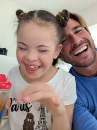 Rio is a blind child with Down syndrome who loves making new friends and  telling jokes. She's full of energy, constantly flapping her hands and  rocking back and forth as she stims