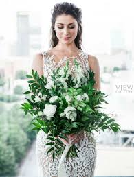Even though this colorado wedding is a long way from an actual beach wedding, these white flowers and pineapple vase brought a tropical wedding vibe to an elegant wedding. Modern All White Tropical Wedding Theme Elegantwedding Ca
