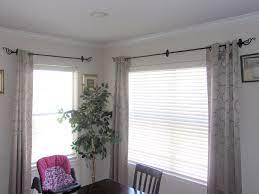 I've found several ways to hang curtains without any drilling, screws, nails, and even over blinds that stick out from the wall. Renter Friendly Way Of Hanging Curtains Without Drilling Holes