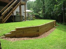 Imagine enhancing a bed's look with a handsome stone, brick, timber, or concrete retaining wall. Trendehouse Trending Interior And Exterior Decor Sloped Backyard Backyard Retaining Walls Backyard