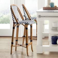This bar stool's seat is woven of natural rattan and the frame is handmade of wood. Parisian Bistro Woven Counter Bar Stool Williams Sonoma