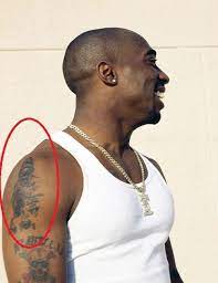 '2pac' tattoo on the left side of his chest. Tupac Shakur S 21 Tattoos Their Meanings Body Art Guru