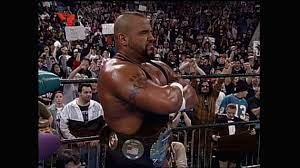 Taz is standing imposingly, arms folded at his opponent on the other side of the ring. He has the ECW title around his waist.