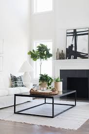 This box frame coffee table is a blank slate, its glass surface the perfect platform for showcasing your most coveted collectibles. Black Box Frame Coffee Table On White And Gray Fringe Rug Transitional Living Room