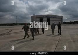 Army 1st Lt. John Dupre, left, a tank commander with the North Carolina  Army National Guard's C Company, 1st Battalion, 252nd Armored Regiment,  uses an impact wrench to tighten bolts