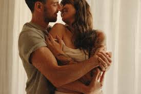 Loving couple in warm embrace, illustrating sexual and emotional intimacy.
