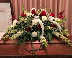 Casket Spray Of Red Roses White Snap Dragons White Carnations And Baby S Breath And Curly Willo Funeral Flower Arrangements Funeral Flowers Flower Arrangements
