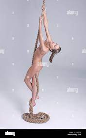 Nude girl climbing rope Stock Photo - Alamy