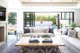 Gray Trays Sit On A Light Wood Coffee Table Placed On A Gray Wool Rug In Front Of Two Light Gray Line Transitional Living Rooms Furniture Decor Interior Design