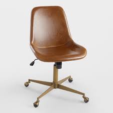 Think a classic black leather desk chair behind a wood desk. Cognac Bi Cast Leather Molded Chair World Market