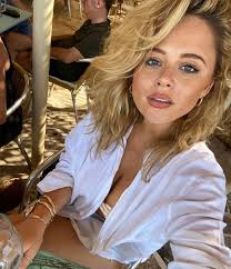 Emily Atack shows off blossoming baby bump as she poses in black crop top