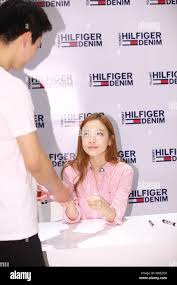 Singer and actress Goo Ha-ra, right, also known as Koo Ha-ra, of South  Korean girl group Kara, hands over her signature to a fan at a signing  event fo Stock Photo -