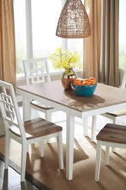 The right materials from a glass dining table that's modern and easy to clean to a sturdy wood kitchen table with bench that adds rustic flair, the right choice is the one. With Its Delicious Two Tone Finish The Brovada Dining Room Table Set Dishes Out A Double Serving Of Clean Li Dining Table Dining Room Sets Dining Table Chairs