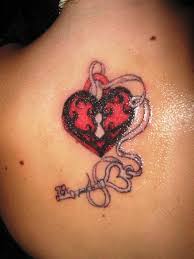 Heart lock and key couple tattoo designs: Pink And Black Heart Shape Lock And Key Tattoo On Upper Back By Josh Clinton