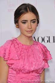 Lily Collins Low Bun Middle Part Low Bun With Soft Pieces Around Ears Middle Part Hairstyles Middle Hair Bridesmaid Hair Bun
