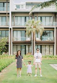 Young Asian family in front of hotel · Free Stock Photo