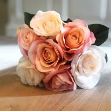 Round bouquets, roses, tulips, or flowers that you always see around can get too ordinary and dull. Faux Flowers Bouquet Of Peach And Cream Roses