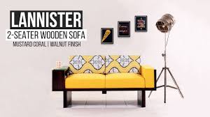 Our choice of leather sofas range from classic curves with tufted details, to chic designs with minimal edges and raised legs. Wooden Sofa Buy Lannister 2 Seater Wooden Sofa Mustard Coral Walnut Finish Online Wooden Street Youtube