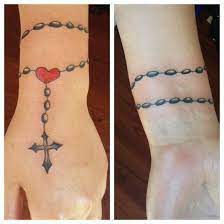 Popular are the tattoos with the beads winded several times around the wrist with a cross falling down the hand or a rosary scattered all over the. 40 Holy Rosary Tattoos Rosary Beads Rosary Cross