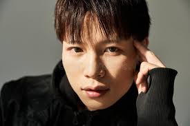 Young Asian Man Showcasing Trendy Facial Stock Photos