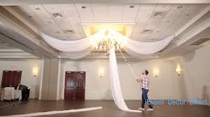The typical height for hanging drapery on a window that has more than 12 inches of space between the top of the window and the ceiling is about 4 to 6 inches above the window trim. Prefabricated Ceiling Drape Kits Instructional Video Youtube