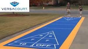 Shuffleboard is a simple but addictive game that involves sliding metal weights (also known as pucks or quoits) down a smooth wooden table to a scoring area at the opposite end. Shuffleboard Court By Versacourt Youtube