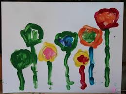 Once children are finished decorating, lay the coffee filters on. Finger Paint Flower Garden Template