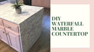 A waterfall countertop is a countertop that 'falls' off the edge of a set of cabinets, creating the appearance of a continuous surface that blends from the top surface down the side. Diy Waterfall Marble Look Countertop For Under 200 Youtube