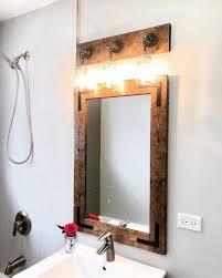 This charming mirror is wonderfully finished with generous and impressive distressed gray driftwood detail and is certain to provide the perfect finishing touch to many types of décor themes. Bathroom Set Rustic Distressed Vanity Mirror With Mason Jar Etsy Rustic Bathroom Decor Mason Jar Light Fixture Bathroom Sets